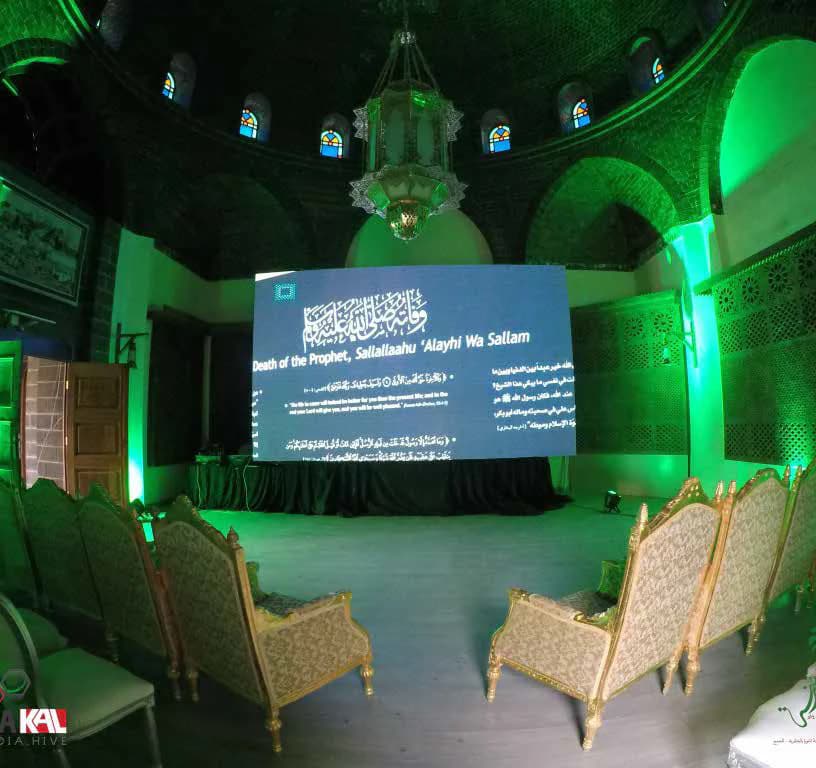 Stage and seating inside an illuminated event environment